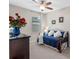 Cozy bedroom with a full size bed, dresser, and a window for natural light at 2249 Palmetum Loop, Apopka, FL 32712