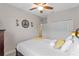 Comfortable bedroom featuring a ceiling fan, decorative wall art and a cozy, inviting bed at 2249 Palmetum Loop, Apopka, FL 32712