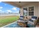 Relaxing covered patio featuring comfortable seating, a fire pit, and a view of the fenced-in backyard at 2249 Palmetum Loop, Apopka, FL 32712