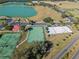 Tennis, basketball, and volleyball courts near a lake at 2249 Palmetum Loop, Apopka, FL 32712