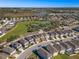 Beautiful aerial view of a residential neighborhood with community pool, tennis courts, and lake views at 242 Aberdeen St, Davenport, FL 33896