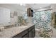 Bathroom with single vanity, shower and green and white shower curtain at 242 Aberdeen St, Davenport, FL 33896