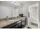 Bathroom with granite countertop double vanity and a shower at 242 Aberdeen St, Davenport, FL 33896