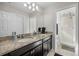 Spacious bathroom featuring double sinks with granite countertops and a separate shower, offering modern convenience at 242 Aberdeen St, Davenport, FL 33896