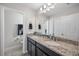 Bathroom features granite countertops with double sinks and ample cabinet space at 242 Aberdeen St, Davenport, FL 33896