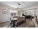 Bright dining room with modern lighting, a stylish table, and an open view to the living area, enhancing the home's appeal at 242 Aberdeen St, Davenport, FL 33896