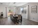 Bright dining area with a large table and six chairs, adjacent to the kitchen at 242 Aberdeen St, Davenport, FL 33896