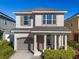 Charming two-story home with a welcoming front porch and well-maintained landscaping at 242 Aberdeen St, Davenport, FL 33896