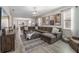 Inviting living room with a large sectional, neutral tones, and seamless flow to the dining area at 242 Aberdeen St, Davenport, FL 33896
