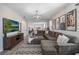 Spacious living room featuring a large sectional sofa and a flat-screen TV at 242 Aberdeen St, Davenport, FL 33896