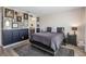 Charming primary bedroom with an accent wall, stylish decor, and private ensuite entrance for added comfort and privacy at 242 Aberdeen St, Davenport, FL 33896