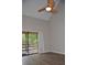 Bright living room with wood-look floors and sliding glass doors leading to a balcony at 242 Orienta Point St # 242, Altamonte Springs, FL 32701