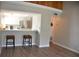 Bright living area with laminate wood floors flowing into the kitchen featuring stainless steel appliances at 242 Orienta Point St # 242, Altamonte Springs, FL 32701