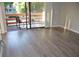 Bright living room with wood floors, a sliding glass door, and a balcony with seating at 242 Orienta Point St # 242, Altamonte Springs, FL 32701