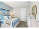 Bright bedroom with a metal bed frame, dresser, and coastal-themed decor at 2592 Kinsale Ln, Ormond Beach, FL 32174