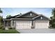 Gray house with three-car garage and stone accents at 2592 Kinsale Ln, Ormond Beach, FL 32174