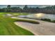 Picturesque golf course with sand traps and a serene water feature at 2592 Kinsale Ln, Ormond Beach, FL 32174