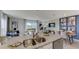 Open concept kitchen and dining area with granite island and sliding door access to patio at 2913 Hudson Hammock Way, St Cloud, FL 34773