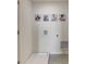 Bright laundry room with dog-themed art and a drain at 2913 Hudson Hammock Way, St Cloud, FL 34773