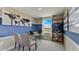 Home office with a desk, chairs, bookshelf, and large window at 2913 Hudson Hammock Way, St Cloud, FL 34773