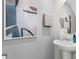 Small bathroom with pedestal sink and framed art at 2917 Hudson Hammock Way, Saint Cloud, FL 34773