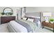 Main bedroom with gray upholstered bed and wood dresser at 2917 Hudson Hammock Way, Saint Cloud, FL 34773