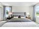 Main bedroom with gray upholstered bed and water view at 2917 Hudson Hammock Way, Saint Cloud, FL 34773
