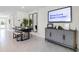 Dining area features a modern table and bench, and a large smart TV at 2917 Hudson Hammock Way, Saint Cloud, FL 34773