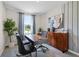 Modern home office with wood desk, comfortable chairs, and natural light at 2917 Hudson Hammock Way, Saint Cloud, FL 34773