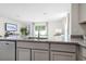 Kitchen island with granite countertop and stainless steel dishwasher at 2917 Hudson Hammock Way, Saint Cloud, FL 34773