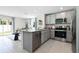 Modern kitchen featuring granite countertops and stainless steel appliances at 2917 Hudson Hammock Way, Saint Cloud, FL 34773