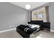 Bright bedroom with a large window and modern platform bed at 3361 S Kirkman Rd # 811, Orlando, FL 32811