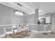 Modern dining room with breakfast bar, glass table, and white chairs at 3361 S Kirkman Rd # 811, Orlando, FL 32811