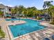 Resort-style pool with comfortable seating and umbrellas at 3361 S Kirkman Rd # 811, Orlando, FL 32811