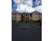 Building exterior featuring a two-story building with columns and parking at 3757 Conroy Rd # 2525, Orlando, FL 32839