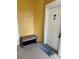 View of the front door with the address number and welcome mat, plus a bench at 3757 Conroy Rd # 2525, Orlando, FL 32839