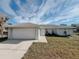 Front view of a single-story house with a white garage door at 4465 Ne 2Nd Ct, Ocala, FL 34479