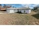 Light gray house with a white garage door and a large yard at 4465 Ne 2Nd Ct, Ocala, FL 34479