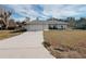 Single story home with attached garage and grassy yard at 4465 Ne 2Nd Ct, Ocala, FL 34479