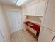 Laundry room with built-in cabinetry and a granite countertop at 4465 Ne 2Nd Ct, Ocala, FL 34479