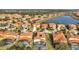 Community overview featuring lake, numerous homes, and lush landscape at 4524 Stella St, Kissimmee, FL 34746