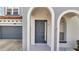 Gray front door with arched entryway and sidelights at 4524 Stella St, Kissimmee, FL 34746