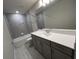 Modern bathroom showcasing a tiled shower with glass door, and a sleek vanity at 4535 Gliding Wave St, Winter Garden, FL 34787