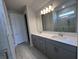 Modern bathroom featuring double vanity, stylish lighting and marble tiled walk-in shower at 4535 Gliding Wave St, Winter Garden, FL 34787