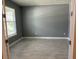 Bright, empty room with lots of space, gray walls, and hard floors, creating a blank canvas for personalization at 4535 Gliding Wave St, Winter Garden, FL 34787