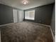 Large bedroom featuring carpet flooring, a window, and freshly painted walls at 4535 Gliding Wave St, Winter Garden, FL 34787