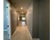 Long hallway with wood flooring, gray walls, and recessed lighting, providing a welcoming transition between spaces at 4535 Gliding Wave St, Winter Garden, FL 34787