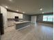 Open-concept kitchen features a large island, stainless steel appliances, and white cabinetry, perfect for entertaining at 4535 Gliding Wave St, Winter Garden, FL 34787