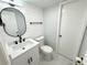 Updated bathroom with stylish vanity, oval mirror, and marble tile floors at 4732 Lighthouse Cir, Orlando, FL 32808