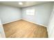 Spacious bedroom with light hardwood flooring and large window at 4732 Lighthouse Cir, Orlando, FL 32808